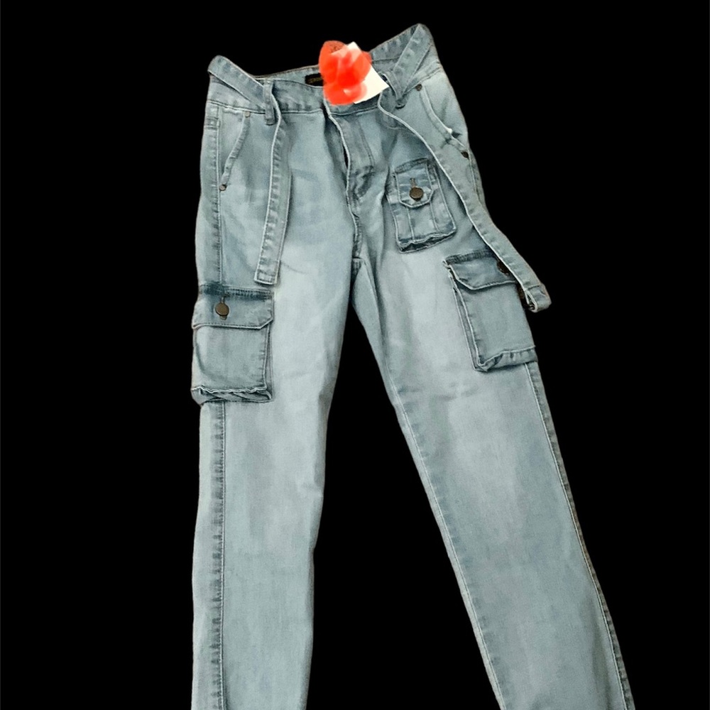 Brand new blue cargo jeans with ruffle bottoms and tie belt.